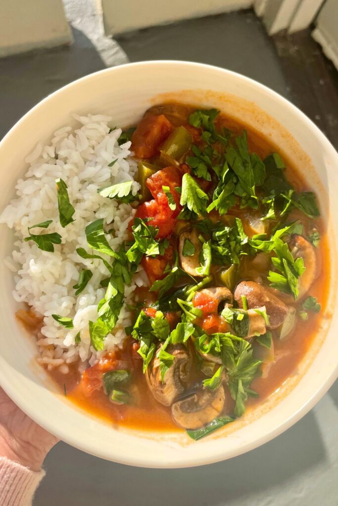 vegan mushroom and spinach etouffee made with a roux and cajun tomato based soup base