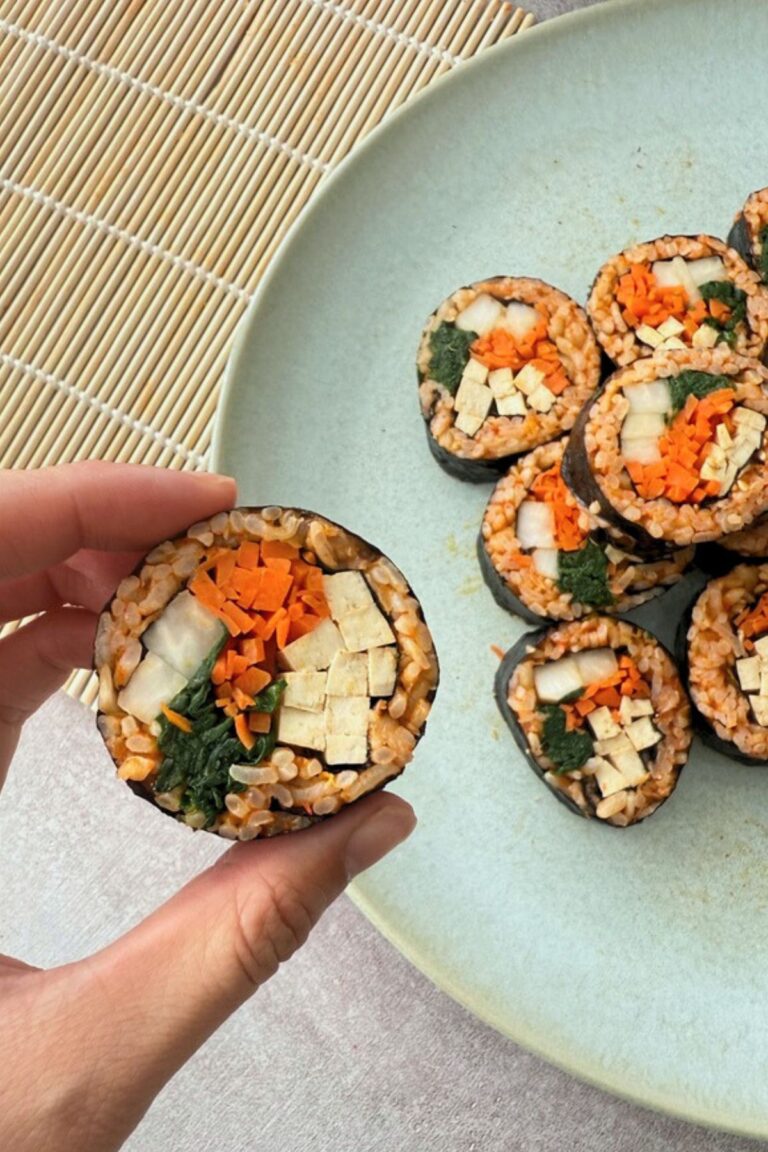 kimchi fried rice vegan kimbap recipe with spinach, carrots, pickled radishes, and tofu