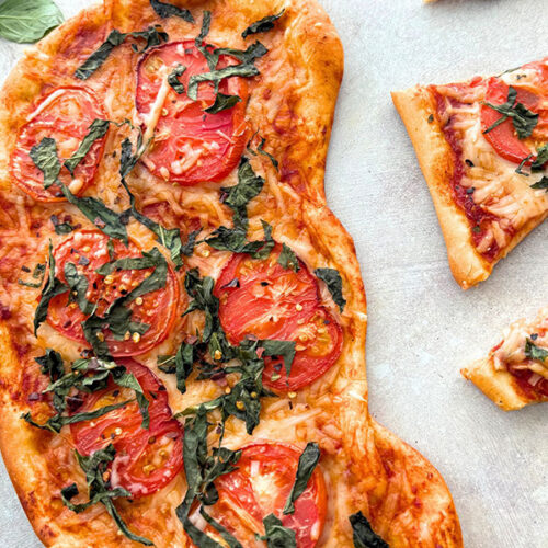 Vegan margherita pizza recipe made with homemade flatbread dough and heirloom tomatoes