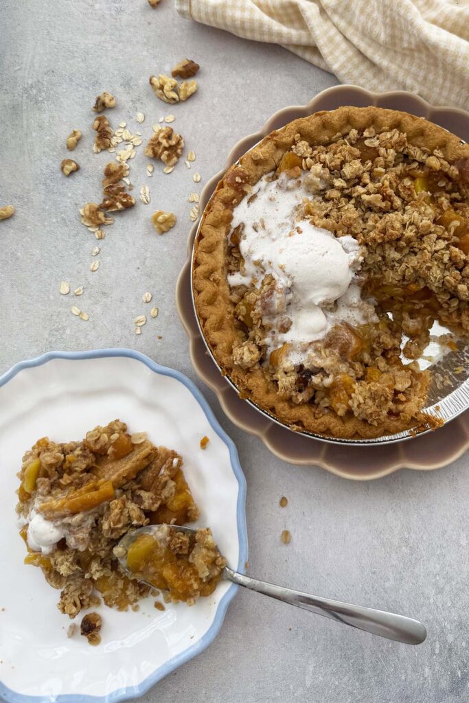 mango and canned peach pie with walnut oats crumble served with non dairy vanilla ice cream