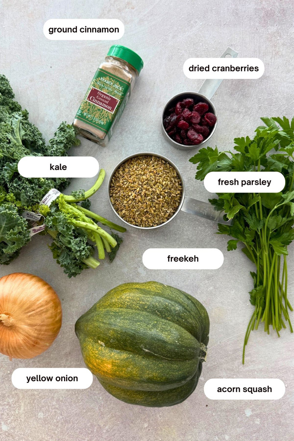 vegetarian stuffed acorn squash with freekeh pilaf ingredients kale, parlsey, cranberries, cinnamon, onion