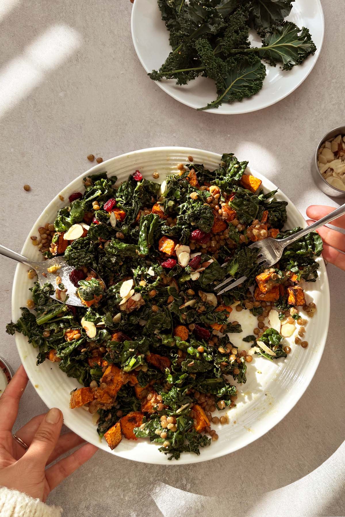 Warm kale and lentil salad with maple dijon poppy seed vinaigrette, sweet potato, and almond slices