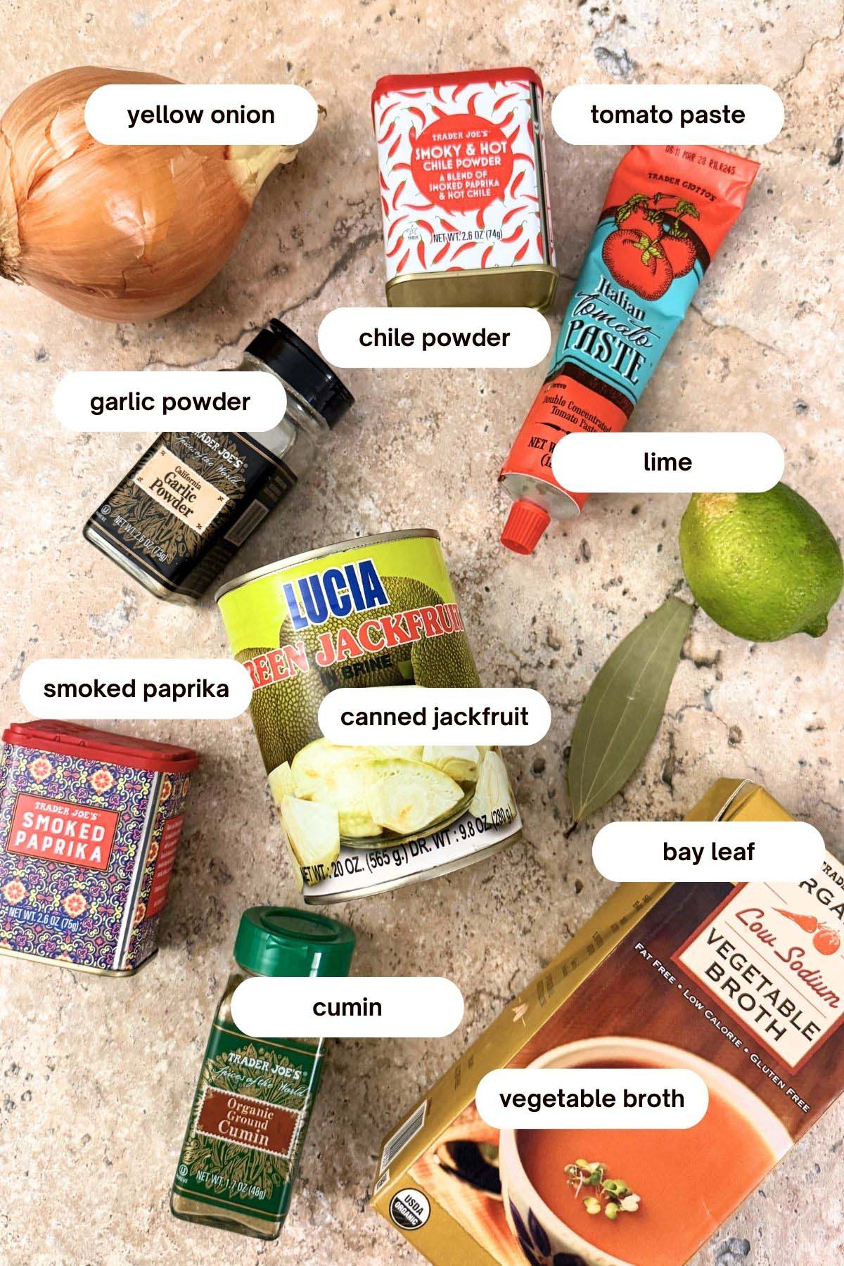 jackfruit carnitas ingredients: canned jackfruit, cumin, onions, smoked paprika, chile powder, tomato paste, bay leaf, garlic powder, vegetable broth, lime