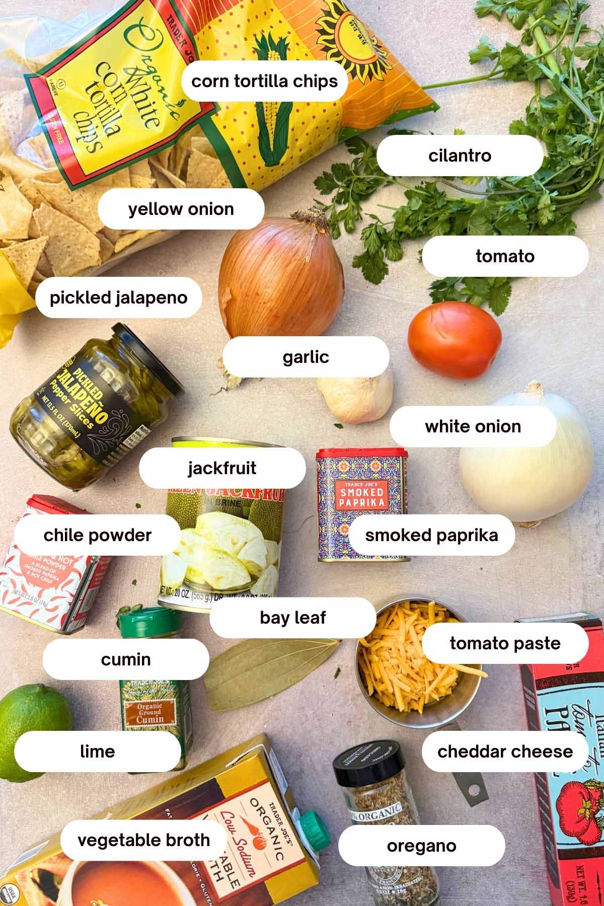 jackfruit nachos recipe ingredients: jackfruit, corn tortilla chips, cheddar cheese, onions, jalapenos, tomato paste, oregano, paprika, garlic, cumin, chile powder, lime, cilantro