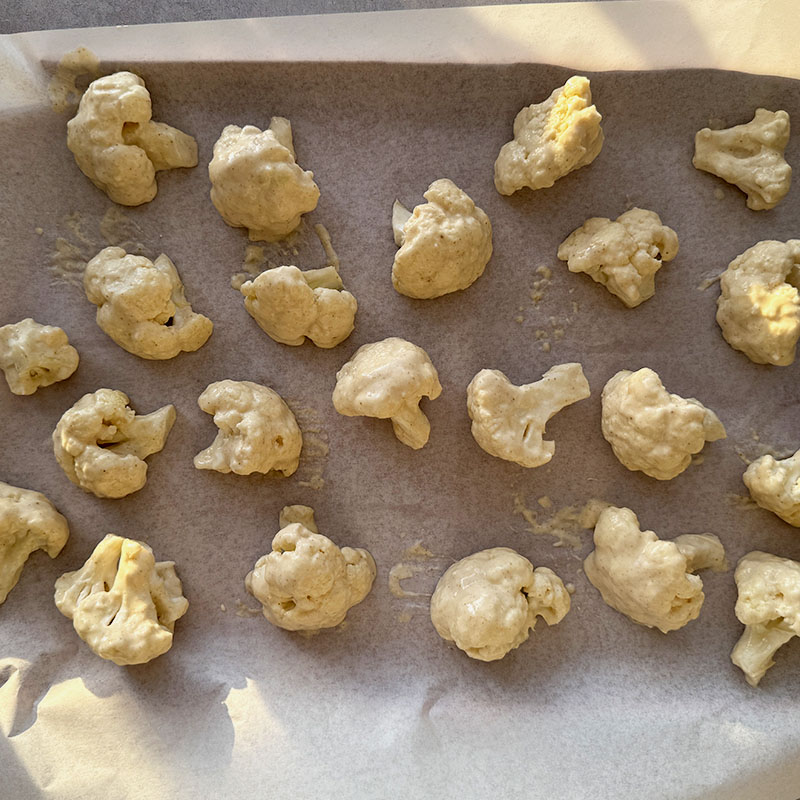 roast cauliflower bites and batter in oven until crispy