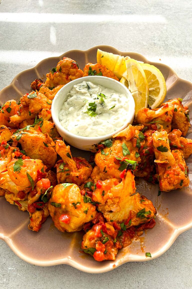 crispy oven roasted cauliflower bites in harissa sauce